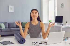 a youung women practing mindfullness at office