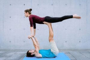 two peron performing bird pose in acro
